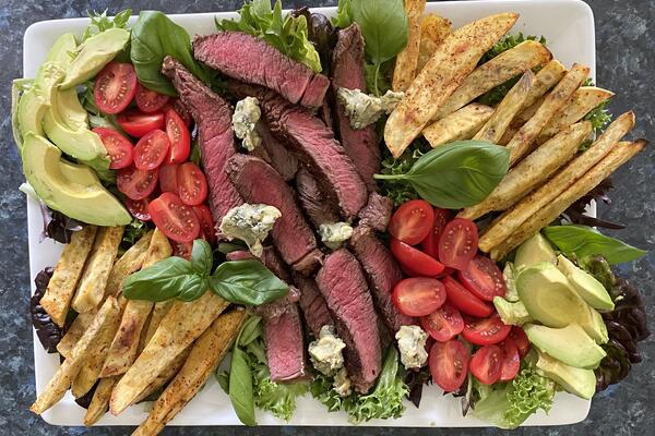 image of Kumera fries, steak with blue cheese butter salad *